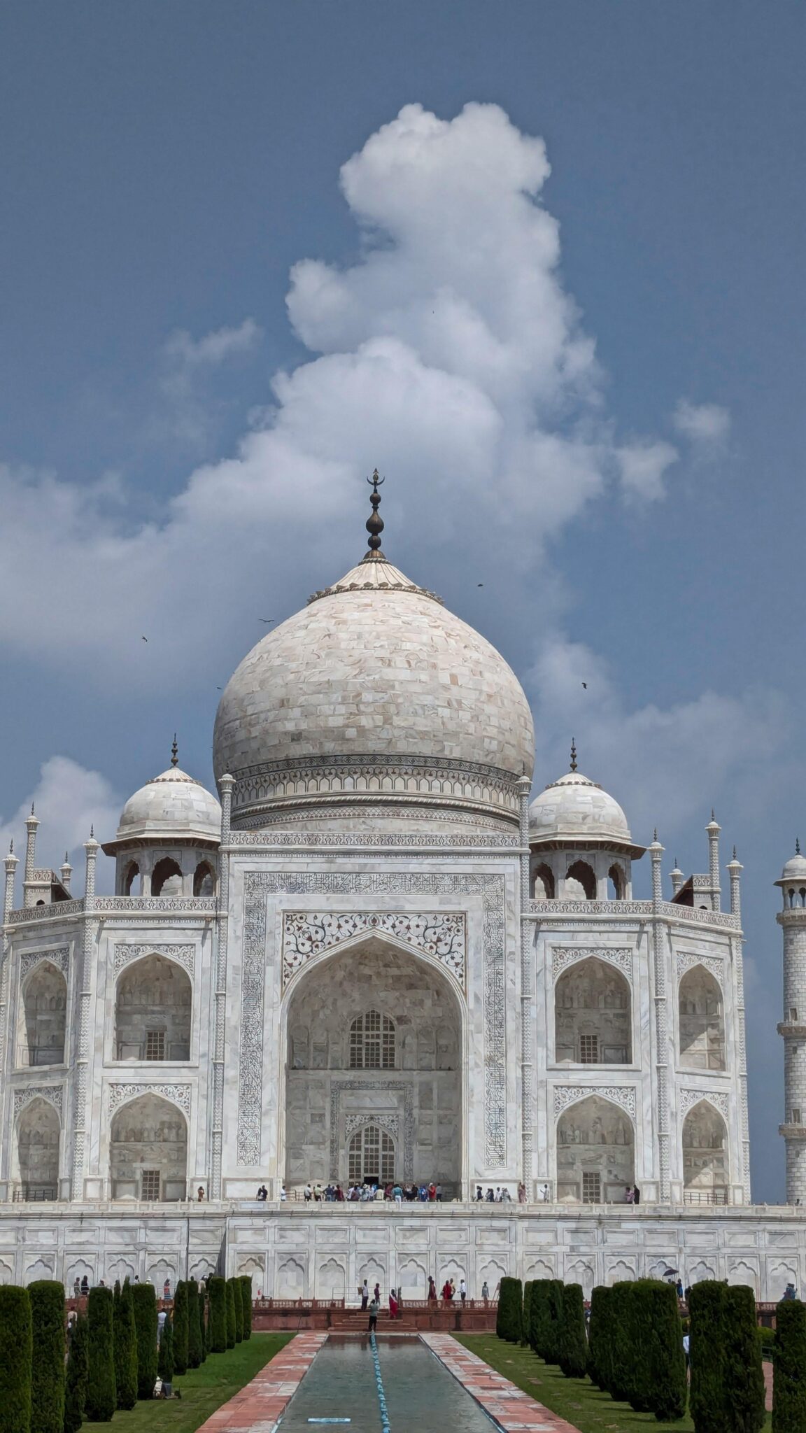 Stunning photo of the Taj Mahal under a clear blue sky, showcasing its architectural beauty.